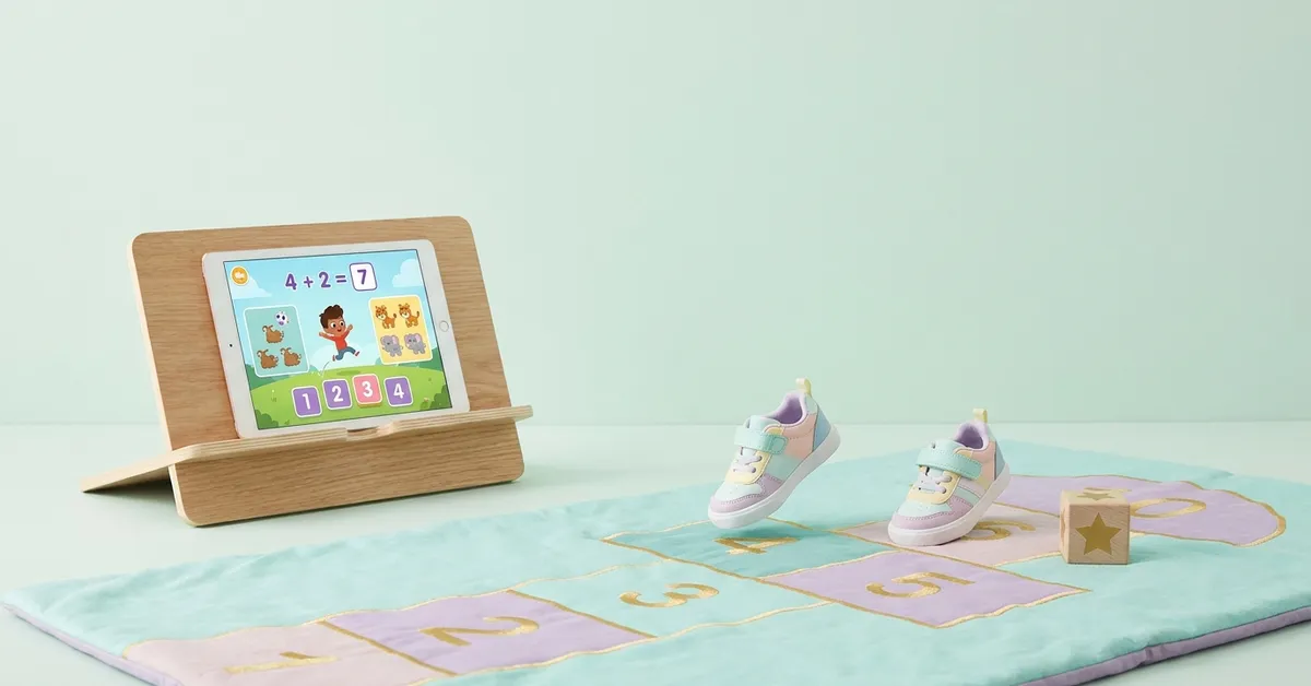 Active screen time: tablet with a kids math game and a hopscotch mat in front, played by moving.