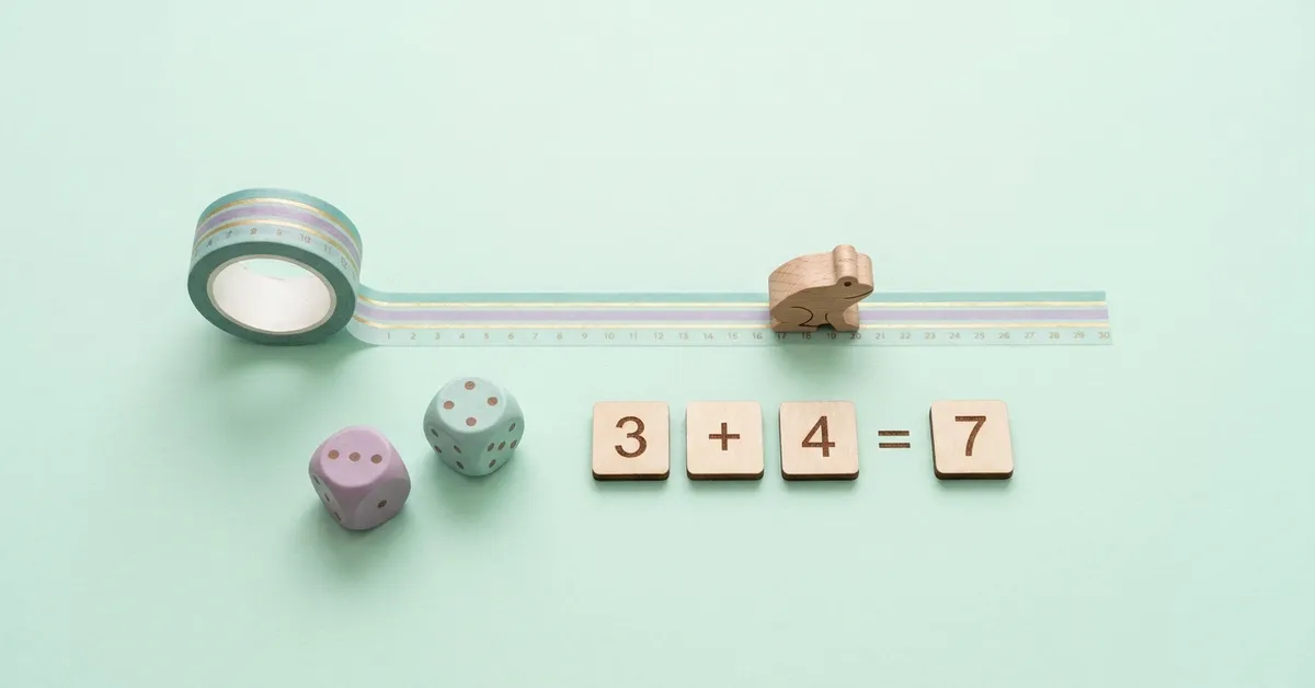 Math operations practice with a tape number line, a wooden frog token, dice and tiles showing 3 plus 4 equals 7.